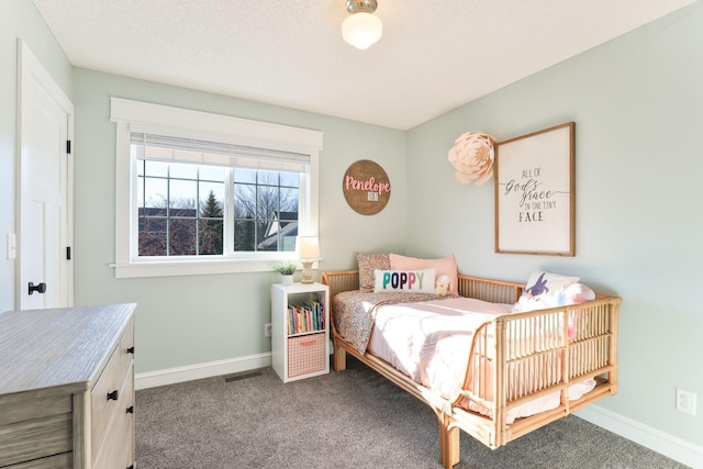 bedroom featuring carpet flooring, visible vents, a textured ceiling, and baseboards