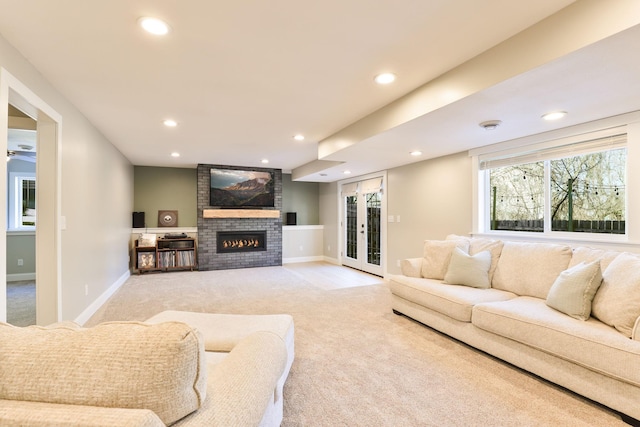 living room with baseboards, recessed lighting, french doors, a brick fireplace, and light colored carpet