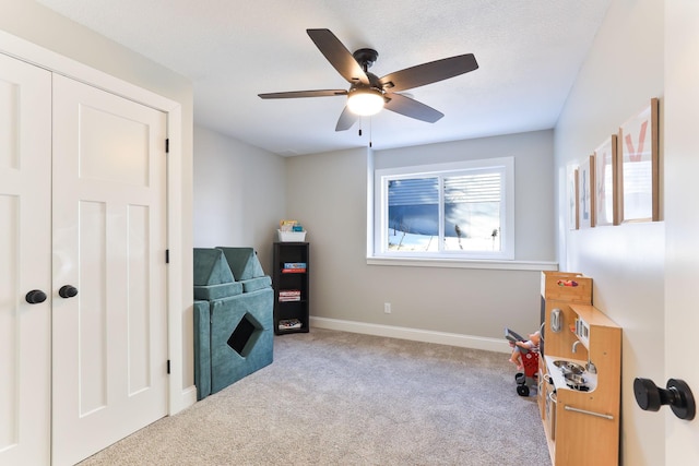 misc room with ceiling fan, baseboards, and carpet