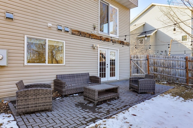 view of patio / terrace with a gate, french doors, and fence