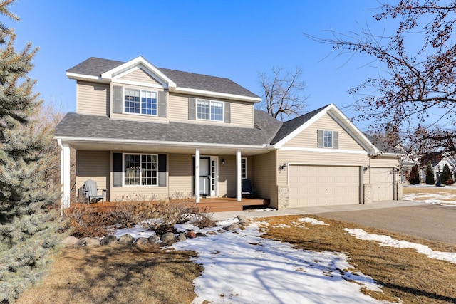 view of front facade featuring aphalt driveway, a porch, a shingled roof, and an attached garage