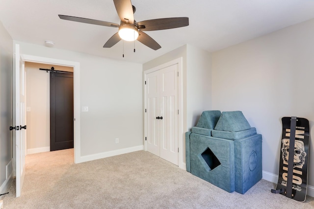 living area featuring carpet, baseboards, and ceiling fan