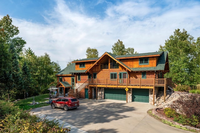 log cabin featuring stairs, stone siding, log exterior, and an attached garage