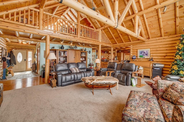 carpeted living area with wooden ceiling, log walls, high vaulted ceiling, and beamed ceiling