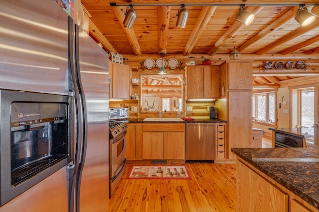 kitchen with stainless steel appliances, a sink, wood ceiling, light wood finished floors, and rustic walls