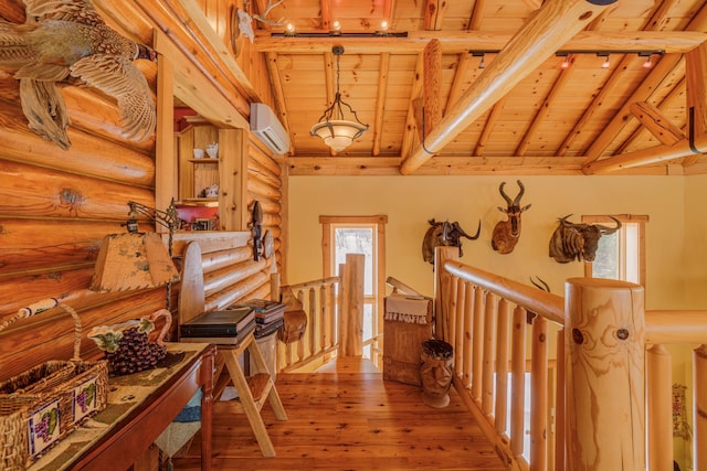 hallway with beam ceiling, wood ceiling, an upstairs landing, and a wall mounted AC