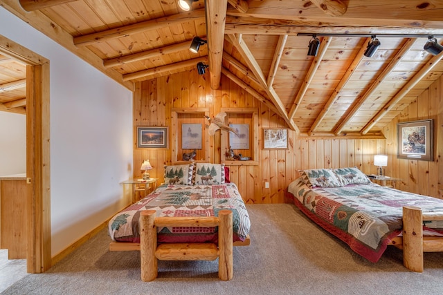 carpeted bedroom featuring lofted ceiling with beams, wooden ceiling, wooden walls, and rail lighting