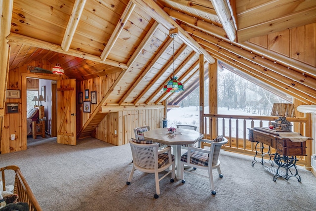 dining space featuring vaulted ceiling with beams, wooden ceiling, carpet flooring, and wood walls