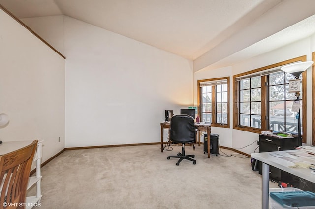 office area featuring baseboards, carpet, and vaulted ceiling