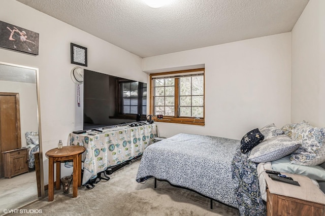 bedroom with a textured ceiling and carpet