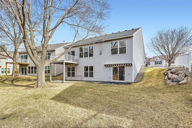 rear view of house featuring a yard
