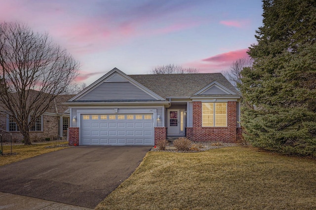 ranch-style home featuring a garage, brick siding, a yard, and driveway