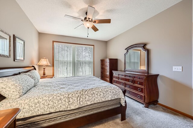 bedroom featuring carpet flooring, a ceiling fan, baseboards, and a textured ceiling