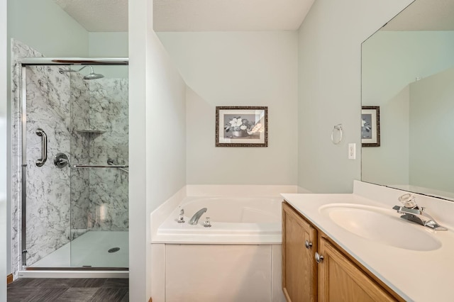 full bathroom with a stall shower, vanity, and a bath