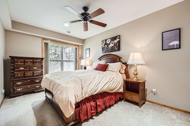 bedroom with a ceiling fan, carpet, and baseboards