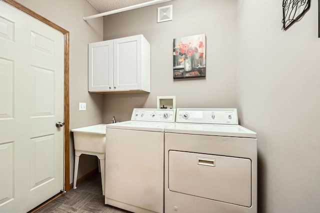 laundry area with cabinet space, visible vents, and independent washer and dryer