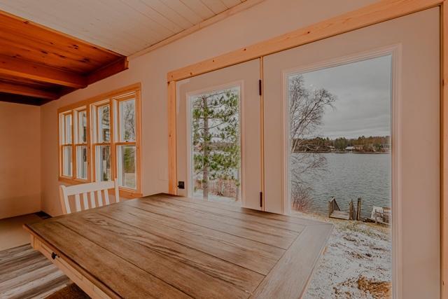 unfurnished dining area featuring wooden ceiling, a water view, and beam ceiling