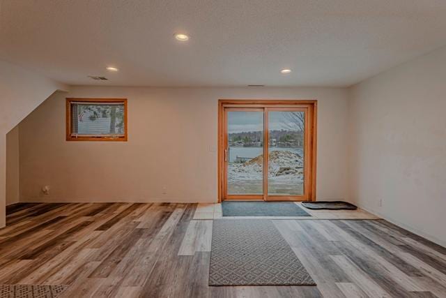 doorway to outside with recessed lighting and wood finished floors