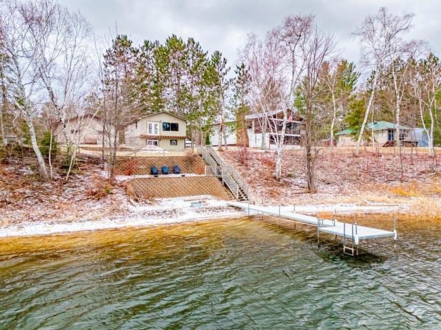 dock area featuring stairs and a water view