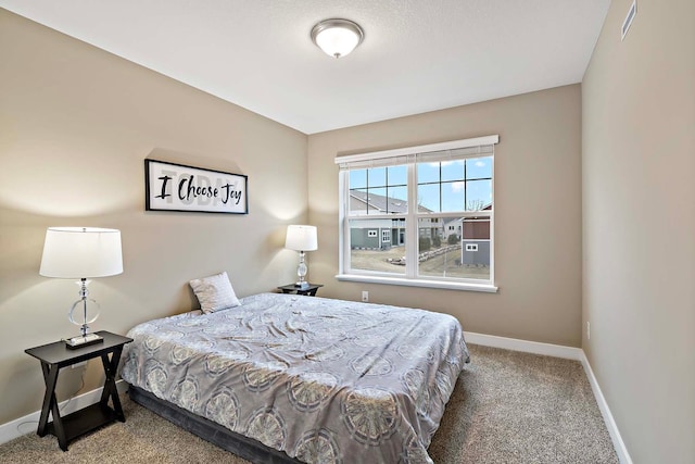 bedroom with carpet floors, visible vents, and baseboards