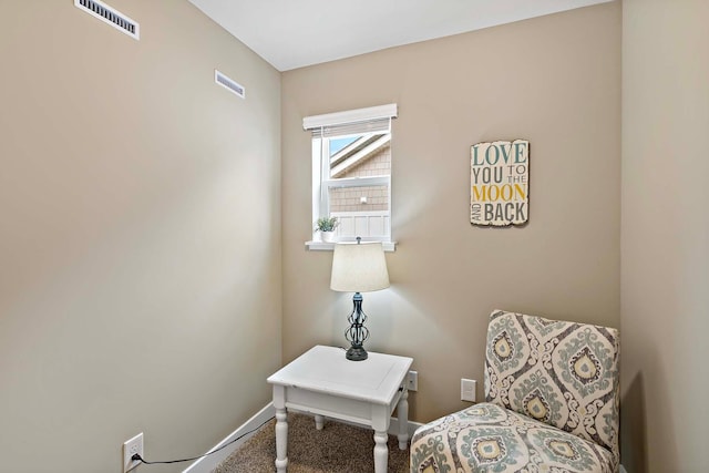 living area with visible vents and baseboards