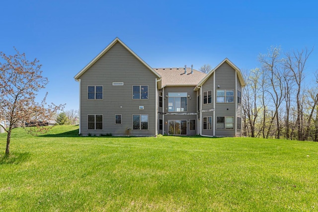 rear view of property with a lawn