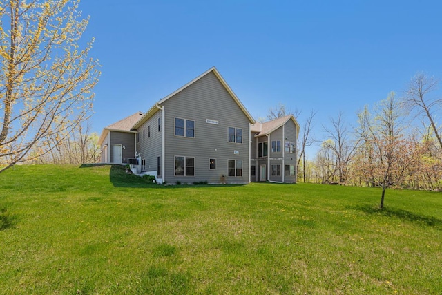 back of property featuring a yard and a garage