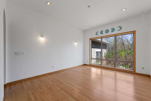 unfurnished room featuring light wood-style floors, baseboards, and recessed lighting