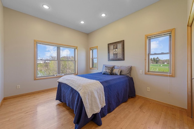 bedroom with light wood finished floors, baseboards, and recessed lighting