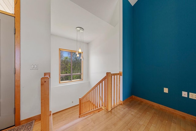 stairs featuring hardwood / wood-style floors and baseboards