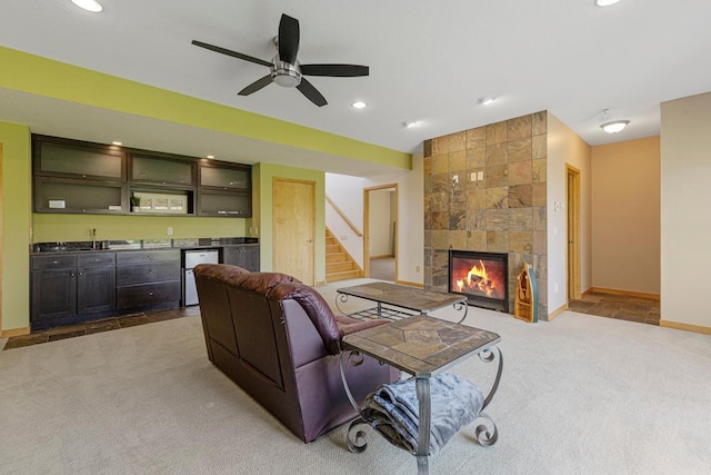 living area with carpet flooring, wet bar, stairway, a fireplace, and recessed lighting