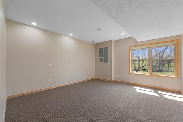 carpeted spare room featuring baseboards, recessed lighting, and a textured ceiling