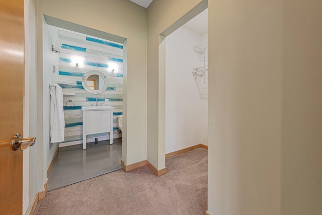 hall featuring carpet floors and baseboards
