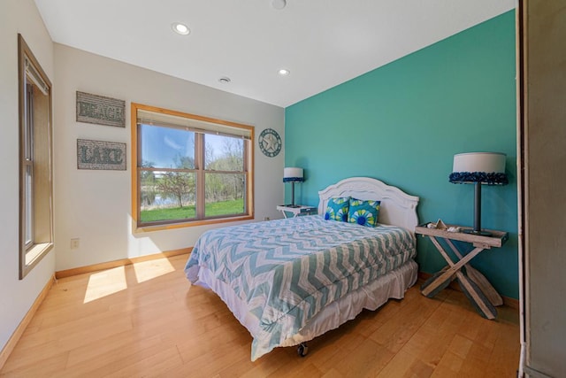 bedroom with wood finished floors, baseboards, and recessed lighting