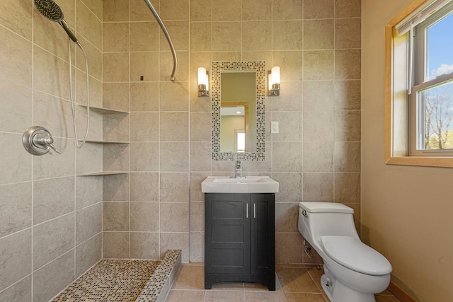 bathroom featuring tiled shower, healthy amount of natural light, and tile walls
