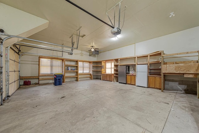 garage with freestanding refrigerator and a garage door opener