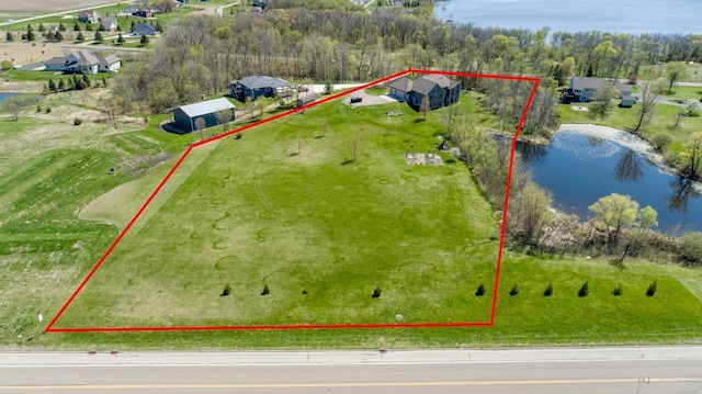aerial view of property and surrounding area featuring a nearby body of water and property boundaries highlighted