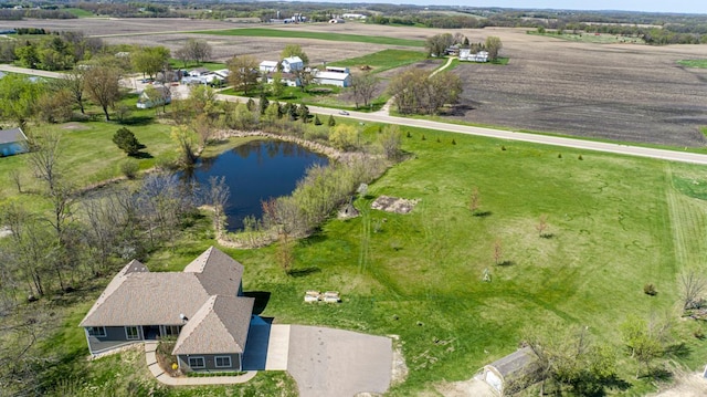 aerial view of property and surrounding area featuring a nearby body of water and rural landscape