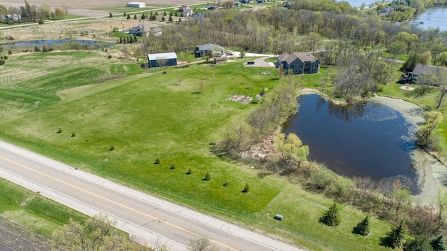 aerial view of property and surrounding area featuring a nearby body of water