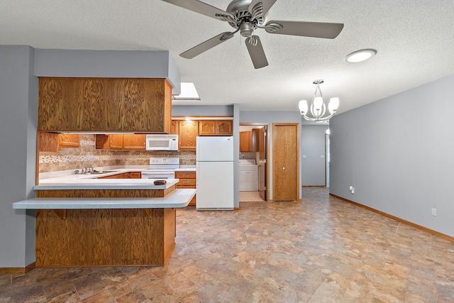 kitchen featuring white appliances, tasteful backsplash, washer / dryer, brown cabinets, and light countertops