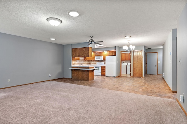 kitchen with light carpet, white appliances, washer and clothes dryer, brown cabinetry, and open floor plan