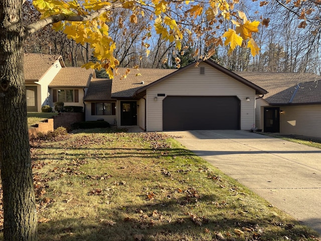 ranch-style house with a garage and driveway