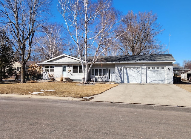 single story home with a garage, concrete driveway, and a front yard