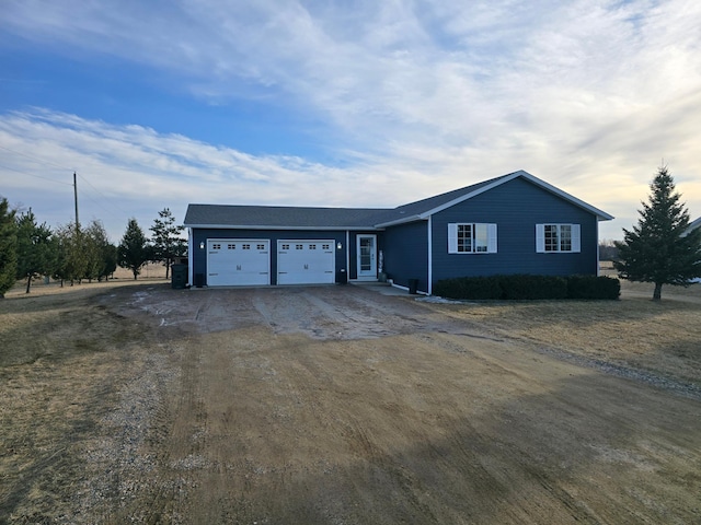 ranch-style house with an attached garage and driveway