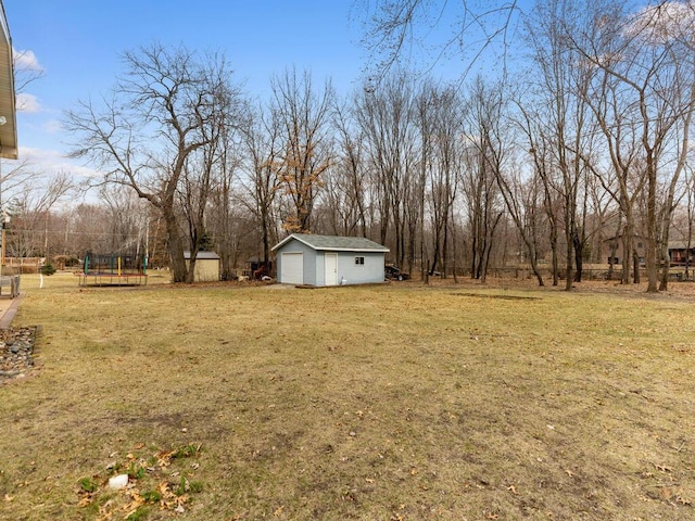 15015 Vermillion Cir NE, Andover, MN 55304 - view of green lawn with an outdoor structure, a garage, and view of wooded area