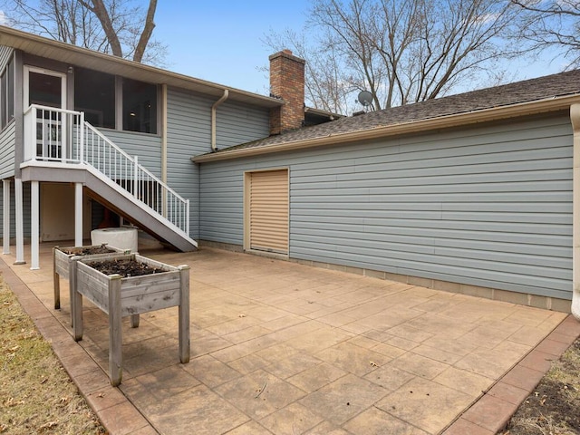 15015 Vermillion Cir NE, Andover, MN 55304 - back of property with a chimney, stairs, a patio, and a sunroom