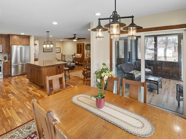 15015 Vermillion Cir NE, Andover, MN 55304 - dining space with a ceiling fan, recessed lighting, light wood-style flooring, and a chandelier