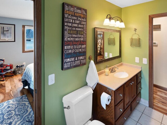 15015 Vermillion Cir NE, Andover, MN 55304 - bathroom with vanity, baseboards, toilet, and tile patterned flooring