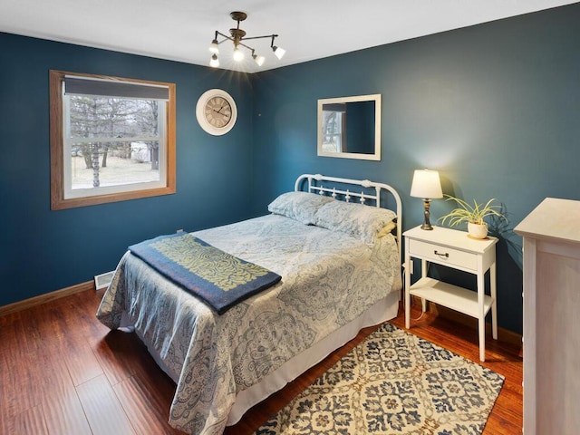 15015 Vermillion Cir NE, Andover, MN 55304 - bedroom with wood finished floors, baseboards, and a chandelier