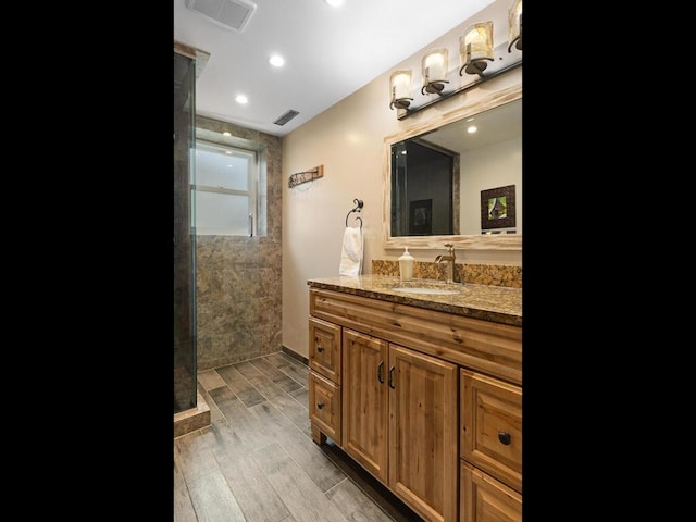 15015 Vermillion Cir NE, Andover, MN 55304 - full bathroom featuring wood finished floors, walk in shower, vanity, and recessed lighting